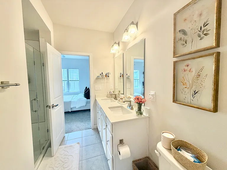 Master bathroom with frameless shower door and dual vanity