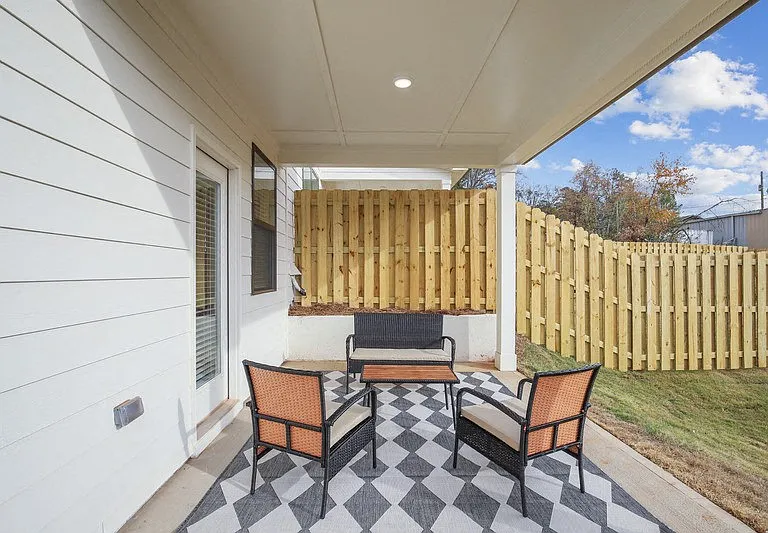 Inviting covered patio overlooking a private, fenced backyardperfect for outdoor gatherings.