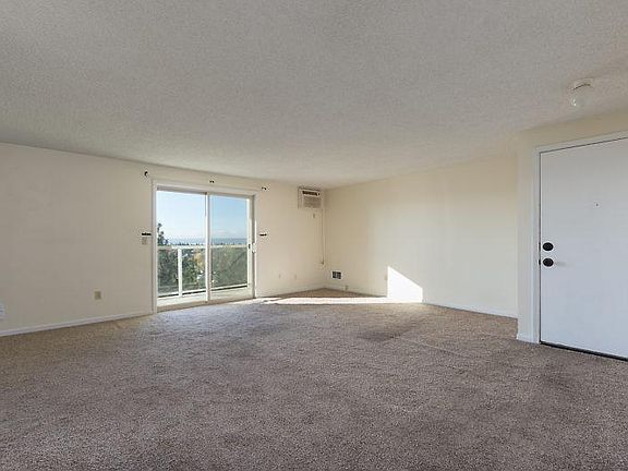 Front door, living room, slider. New carpet!