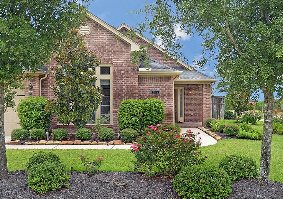 Lovely home with gable roofs and attractive brick is set back off the road and is professional lands