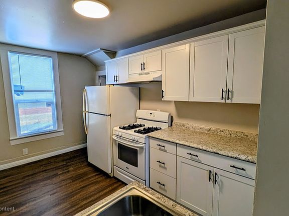 Kitchen cabinets, refrigerator, gas stove