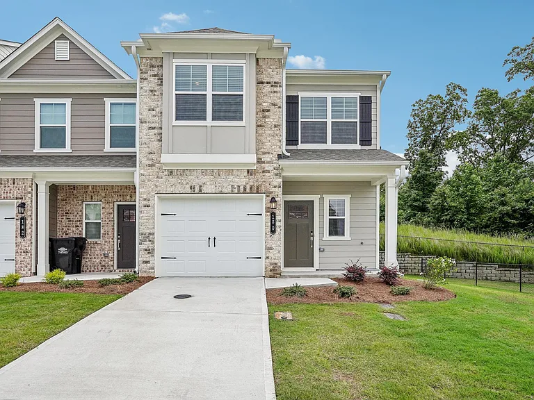 Exterior shot of Waterford layout, two story townhome with a private driveway and attached garage.