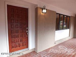 Front door within front arched patio