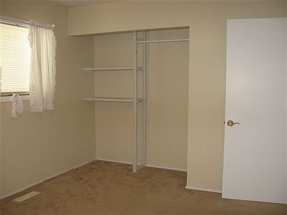 3rd bedroom with laminate floor and abundant closet space