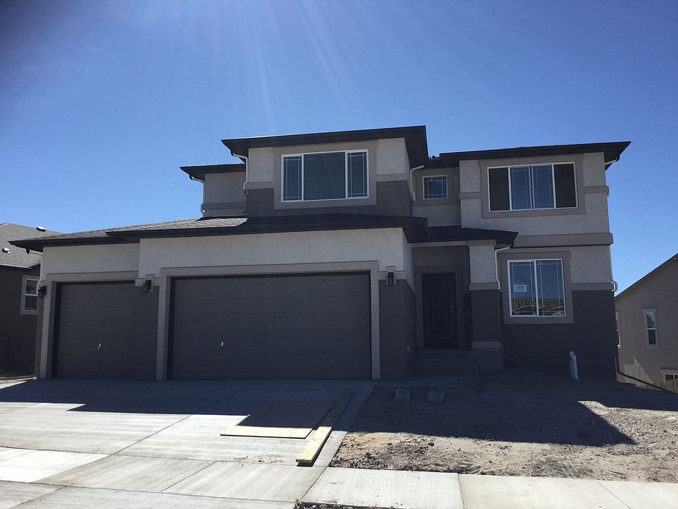 Exterior almost complete on this popular 2-story with 4-car garage, finished lower level and amazing walk-out home site! (Photo of home under construction)
