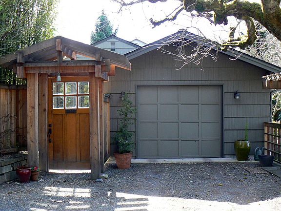 Entry off NE 32nd into private courtyard. One car garage with side storage has door into courtyard.