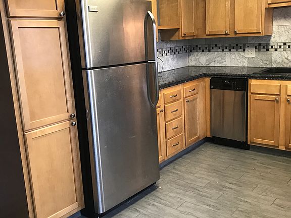 Updated kitchen with stainless steel appliances and granite countertops