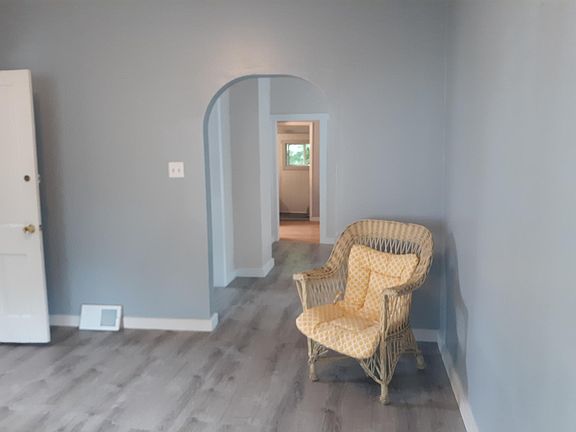 Living room looking through dining room and kitchen to back porch