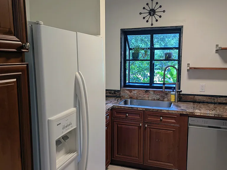 Kitchen, sink with bay window overlooking the backyard and firepit.