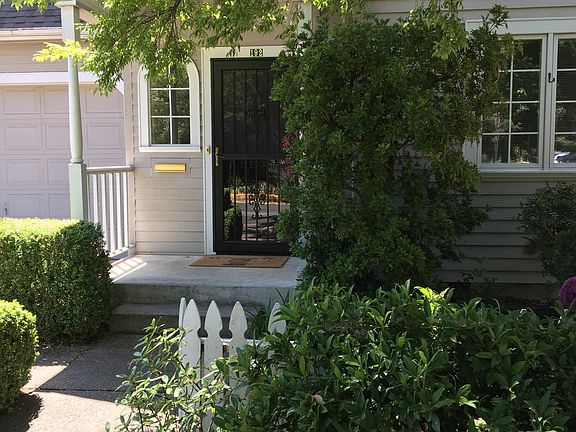 Double front door with wooden door and metal security/storm door.