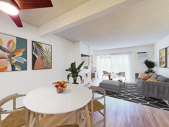 Dining area and living room at Village Pointe Apartment Homes