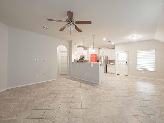 Living room space, open kitchen with view of backyard and dinning area