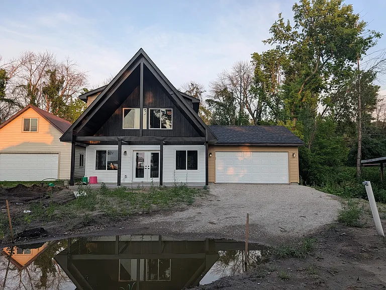 Exterior view the home with attached two-car garage. Yard will have sod and the driveway will be paved prior to move-in date.