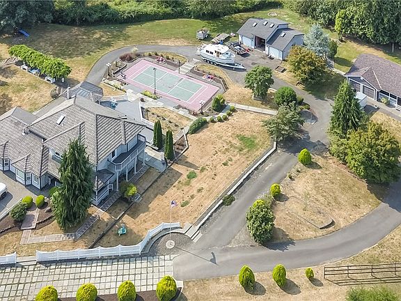 A paved roadway leading into the property and generous areas of parking outside the main home, rambler and the over sized garage.