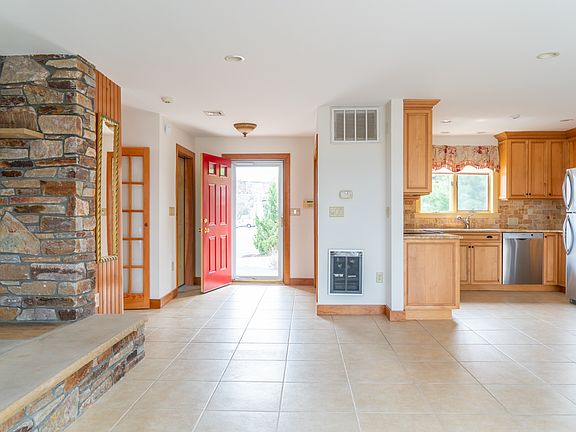 Open living space facing front door and kitchen