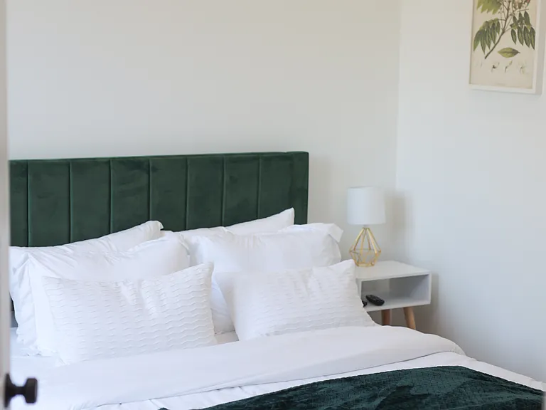 First floor bedroom with attached bathroom and patio door.