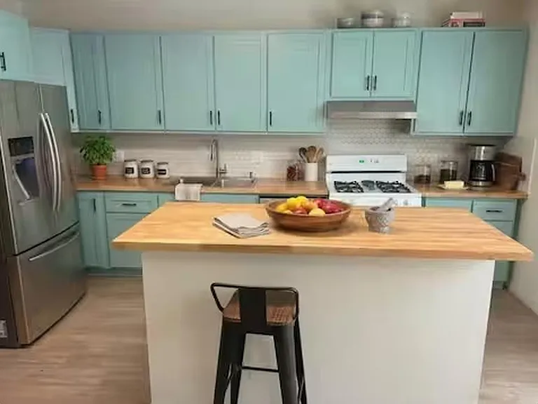 Raised breakfast countertop with bar stools, perfect for morning coffee, casual meals, or a comfortable workspace.