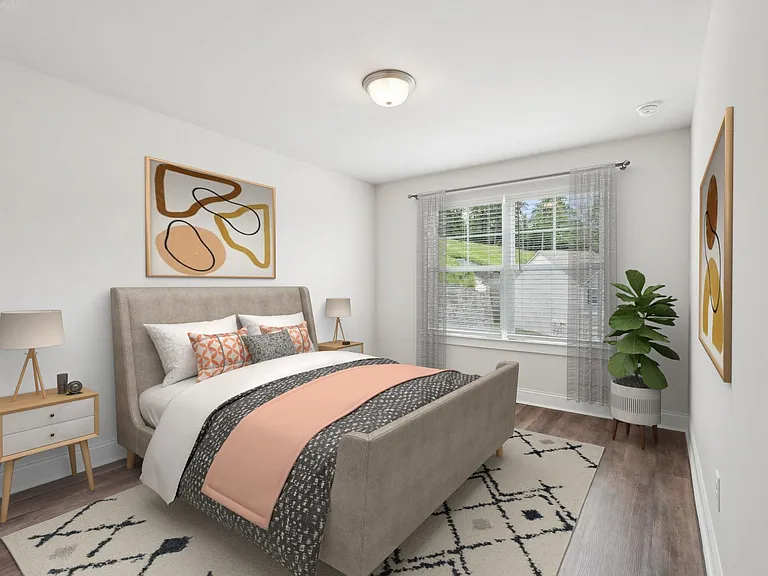 Secondary bedroom with queen size bed and large window letting in a ton of natural light.