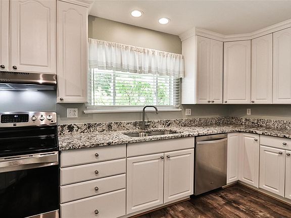 Kitchen includes stainless steel appliances and recessed lighting