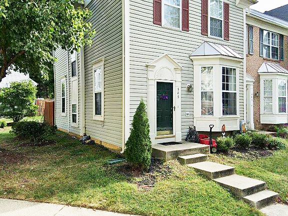 Street view of house. End unit that gets lots of sunlight.