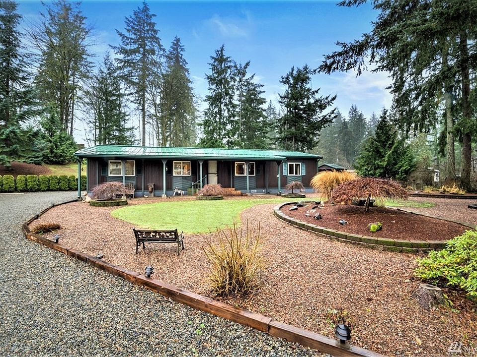 Front entrance to home right after power gate. Sculpted yard Japanese Maples everywhere! Metal roof covering home, front and back patio's.     
