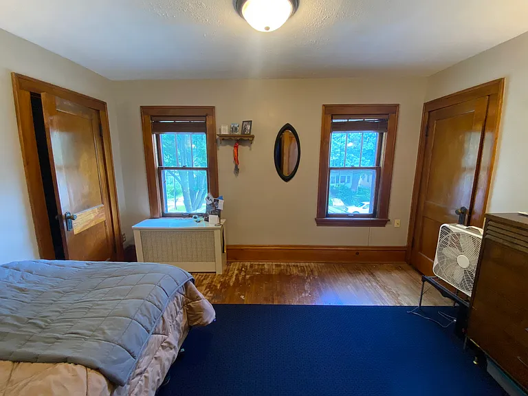 Upper-level front bedroom with two generously sized closets on either side