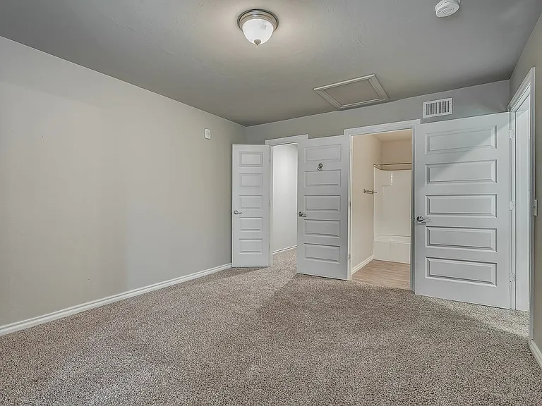 Explore this tranquil bedroom with access to a private ensuite bath, perfect for relaxation.