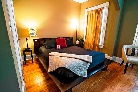 Large room comfortably fits two beds, work space, and sittin
