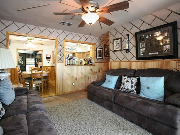 The living room and the hallway by the bedrooms have a ceramic tile floor.