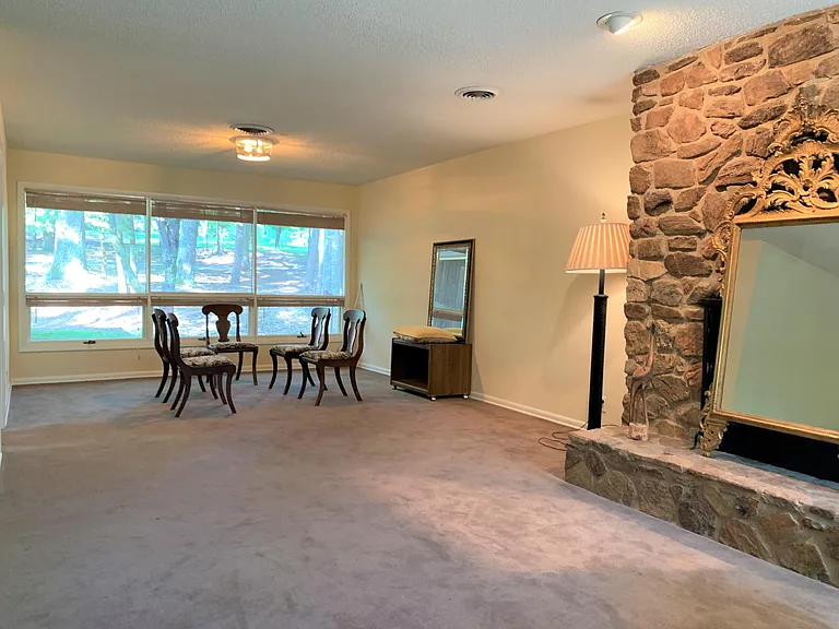 Living Room and dining area. Note: carpeting was recently replaced with waterproof laminate flooring. Updated photos to follow.