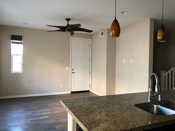 Living/family room with ceiling fan and laminate hardwood flooring.