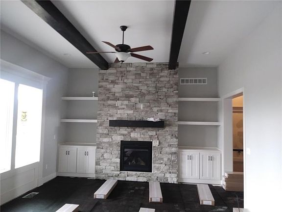 A stone fireplace flanked by built ins is de rigueur for this living room