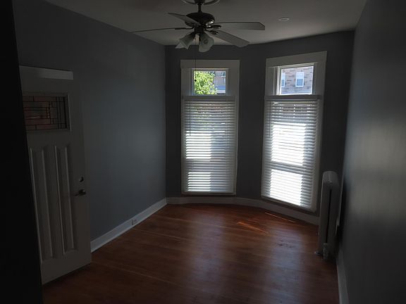 Living room with new bay windows and ceiling fan