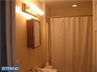 Upgraded bathroom with recessed lighting above the shower.