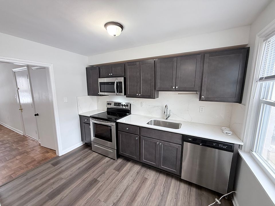 Galley Kitchen with Range, Refrigerator, Dishwasher & Microwave with Corian Counter Tops