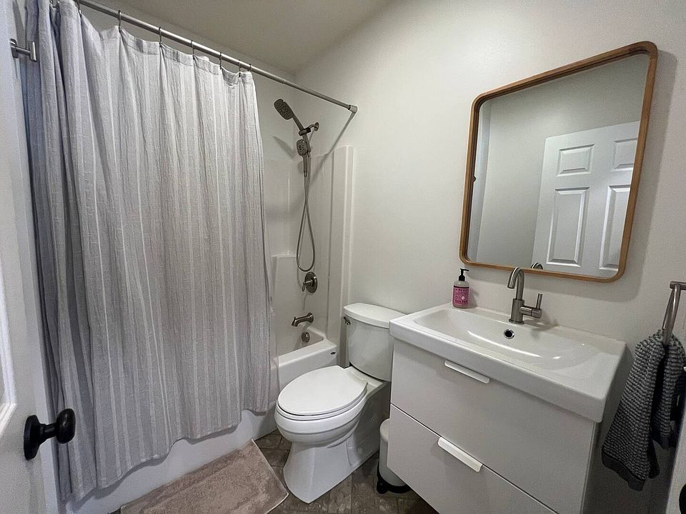 Full bathroom with handheld shower head