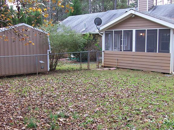 Fenced in yard with storage