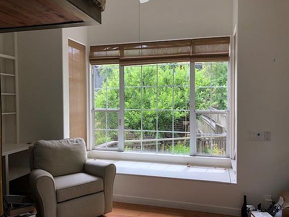 Large picture window overlooking creek with bench seating. Lots of storage under seating.