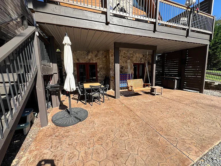 Outdoor covered patio area with built-in wooden swing.