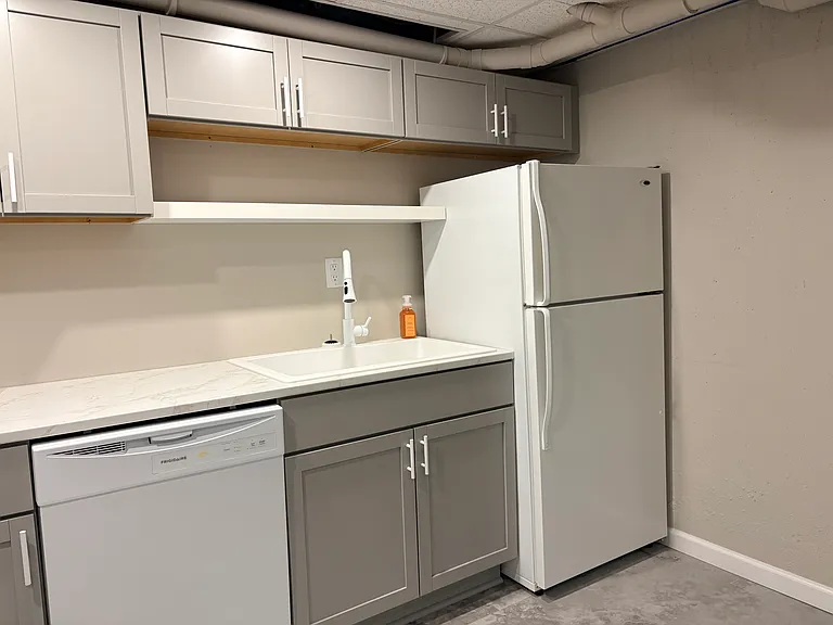 Refrigerator with top freezer, dishwasher.