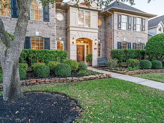This home offers great curb appeal with its lush landscaping and mature trees!