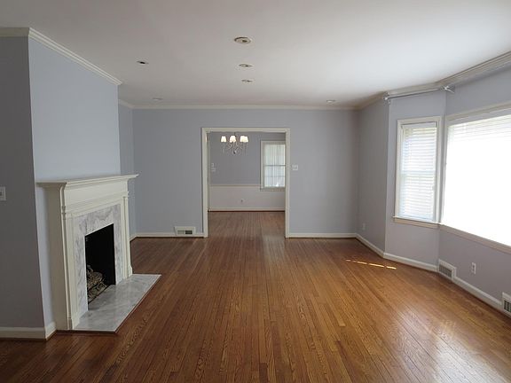 living room with hardwood floors, fireplace, and bay window