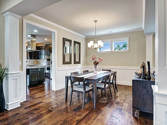 Elegant Formal Dining Room with chair rail wainscoting and crown molding