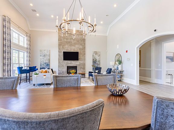 Chandelier and recessed lighting brighten spacious clubroom at Heron Lake