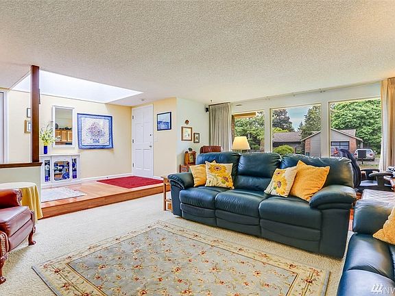 Enjoy an abundance of sunlight from floor to ceiling picture windows along the front of the home.