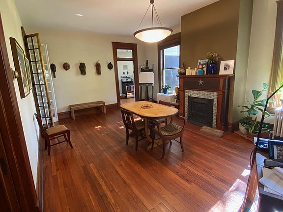 Oversized dining room with decorative fireplace offers extra room for a desk or sofa etc.