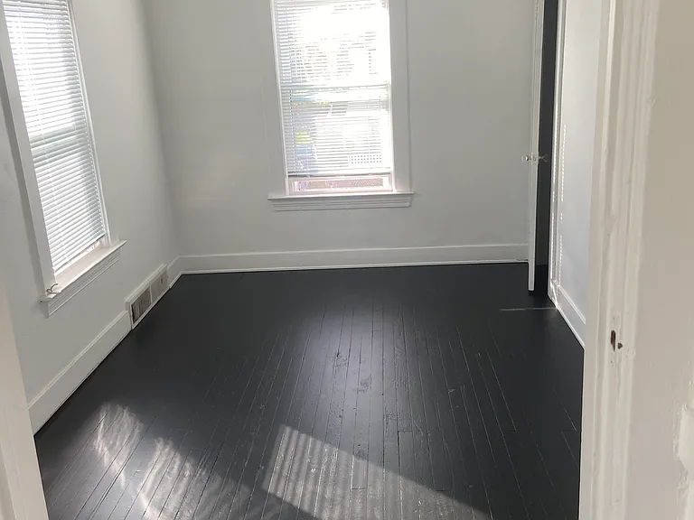 Front bedroom w/corner closet and access from bathroom and front hallway.