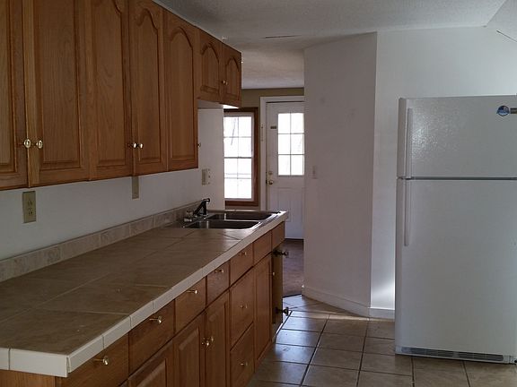 Kitchen with new countertop, and stove.
