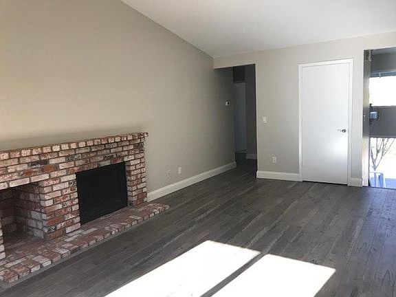 Living room with cathedral ceiling and slider to deck and fi