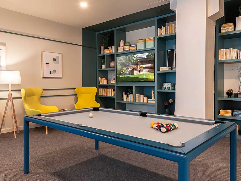 Gather for a game or unwind with a good book Eleven33's lounge brings together bold design, bright color, and laid-back comfort.